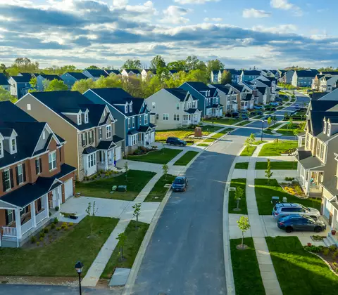 Darstellung einer langegezogenen Straße wo Einfamilienhäuser nebeneinander stehen 